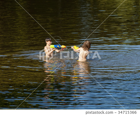 Two Boys Fighting with Squirt Guns. Two Boys Fighting with Squirt Guns. 34715366