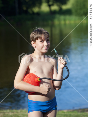 Portrait of a Boy Playing with a Foot Air Pump 34715370