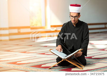 Religious muslim man praying inside the mosque 34715975