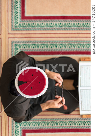 Top view of a religious muslim man praying inside 34716203