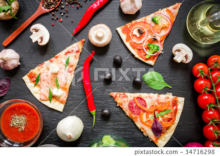 Pizza with ingredients and vegetables on dark Pizza with ingredients and vegetables on dark 34716298