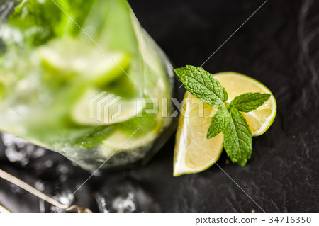 Mojito cocktail on dark background Mojito cocktail on dark background 34716350