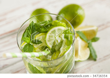 Mojito cocktail on white wood background Mojito cocktail on white wood background 34716354