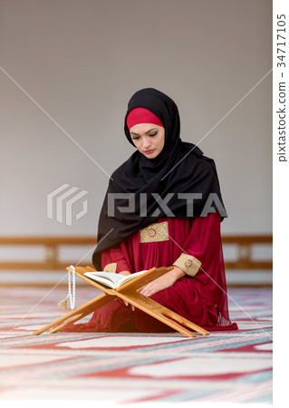 Young muslim woman praying in mosque Young muslim woman praying in mosque 34717105