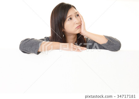 A woman with anxious expression A woman with anxious expression 34717181