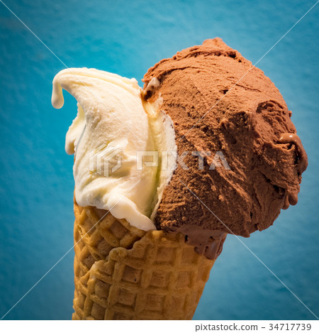 Italian gelato (vanilla and chocolate) on a cone Italian gelato (vanilla and chocolate) on a cone 34717739