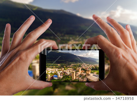 Travel concept. Hands making photo of Svaneti Old Travel concept. Hands making photo of Svaneti Old 34718958