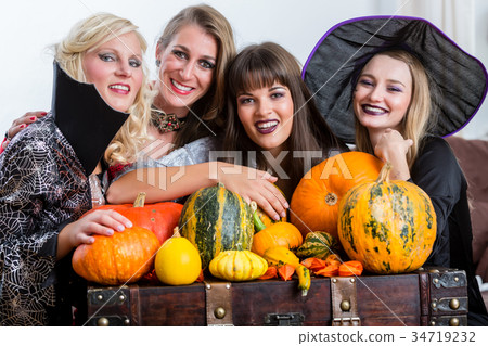Four cheerful women celebrating Halloween together 34719232