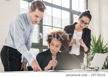 Young female employee asking for advice her 34719233