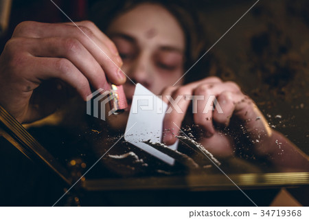 Close-up of the hands of an addicted young man Close-up of the hands of an addicted young man 34719368