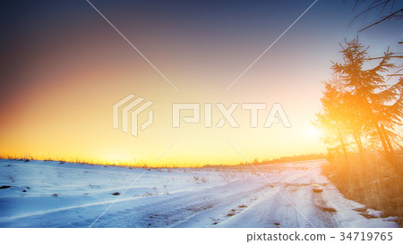 traces of the car wheels on a snowy road 34719765
