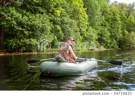 A fisherman in a boat A fisherman in a boat 34719835