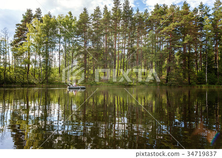 A fisherman in a boat A fisherman in a boat 34719837
