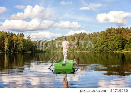 A fisherman in a boat 34719986