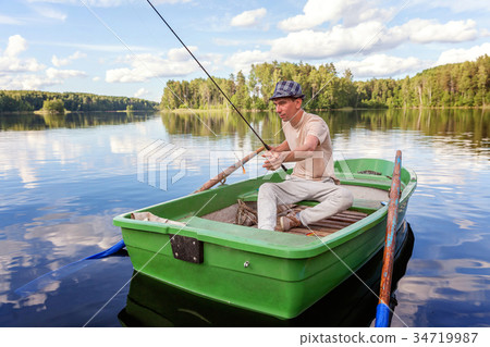 A fisherman in a boat 34719987