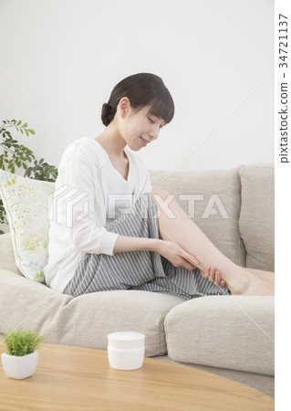 Woman massaging feet at home 34721137