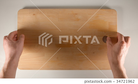 TOP VIEW of hands putting a cutting board TOP VIEW of hands putting a cutting board 34721962