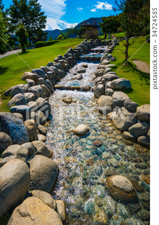 Summer sky and clear stream scenery of artificial river and fruit park Summer sky and clear stream scenery of artificial river and fruit park 34724585