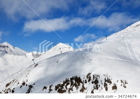 Off-piste slope and chair-lift on ski resort Off-piste slope and chair-lift on ski resort 34724674