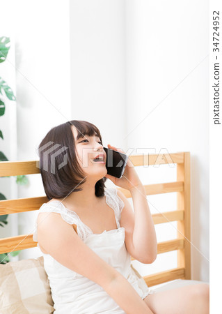 Woman making phone call with smartphone 34724952