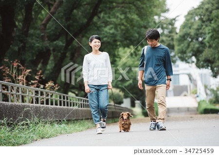 Japanese couple taking a dog walk 34725459