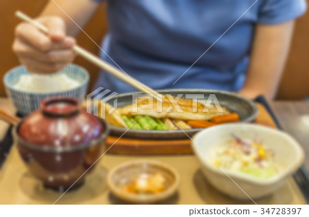 Blurred image of woman eating Japanese fish steak 34728397