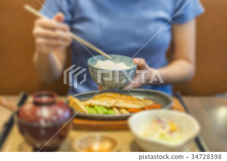 Blurred woman eating Japanese fish steak 34728398