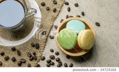 Colorful macaroons and a coffee on gray background. Colorful macaroons and a coffee on gray background. 34729168