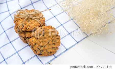 chocolate chip cookies on a white wooden table. 34729170