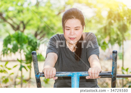 Fitness fat women outdoors in park. 34729380
