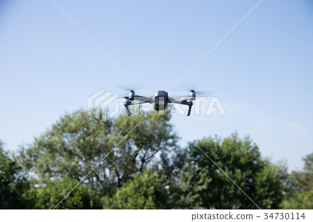 Drone flying in the sky 34730114