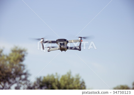 Drone flying in the sky Drone flying in the sky 34730123