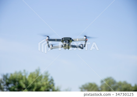 Drone flying in the sky Drone flying in the sky 34730125