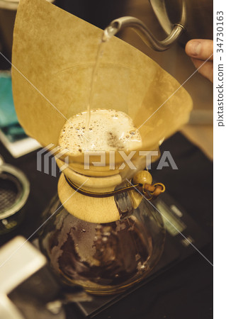 Barista pouring water to coffee Barista pouring water to coffee 34730163