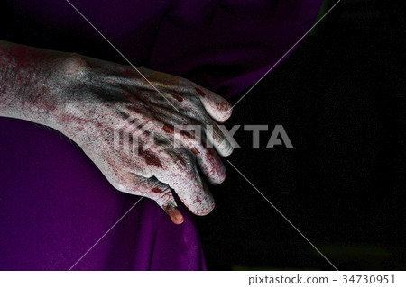 zombie hand coming out from behind a stage curtain 34730951