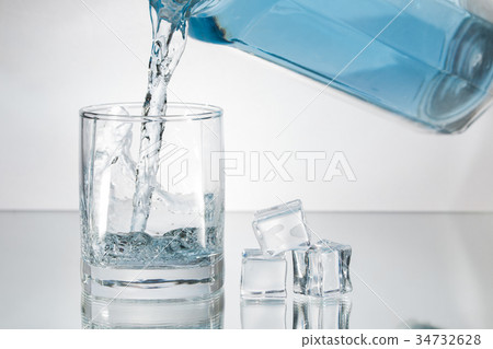 Decanter filling in glass of water splash Decanter filling in glass of water splash 34732628