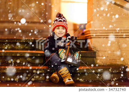 Little cute kid boy with with a light lantern on Little cute kid boy with with a light lantern on 34732740