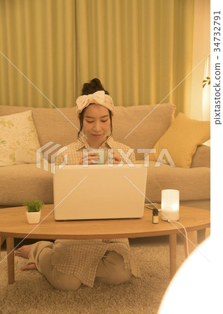 A woman relaxing at night with a PC 34732791