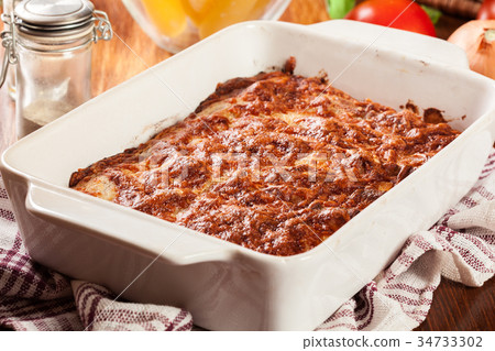 Italian cannelloni pasta baked in casserole dish 34733302