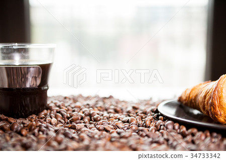 Coffee beans, donut and a cup of coffee Coffee beans, donut and a cup of coffee 34733342