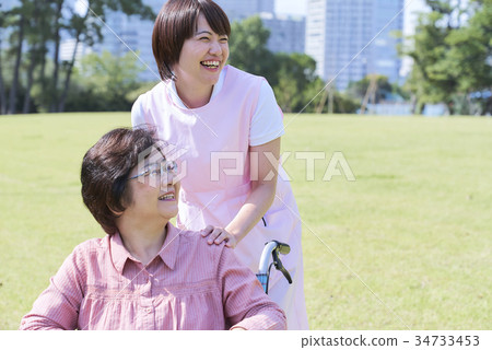 Senior and helper who talks happily Senior and helper who talks happily 34733453