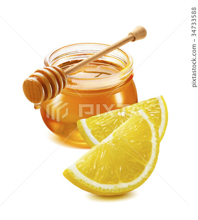 Honey jar and lemon pieces isolated on white Honey jar and lemon pieces isolated on white 34733588