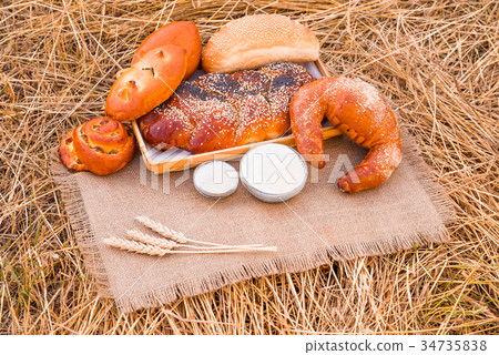 Bakery products lying on a tablecloth 34735838
