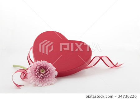 Heart shaped gift box with gerbera and ribbon vertical position 34736226