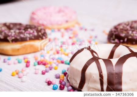 Different type of donuts on white wooden Different type of donuts on white wooden 34736306