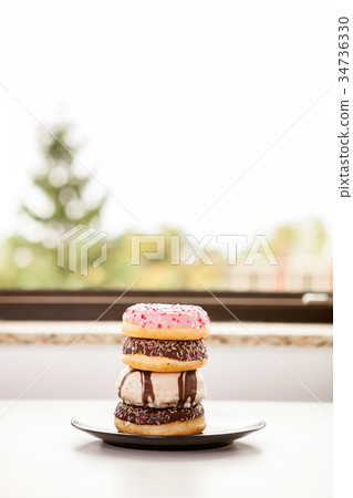 Plate with donuts next to window Plate with donuts next to window 34736330