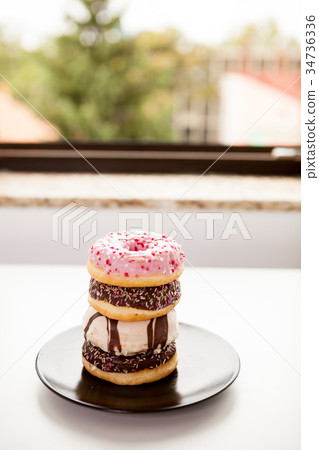 Plate with donuts next to window 34736336