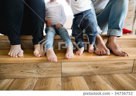 Beautiful young family. Bare feet of mother Beautiful young family. Bare feet of mother 34736752