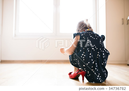 Unrecognizable little girl in dress and red high Unrecognizable little girl in dress and red high 34736782