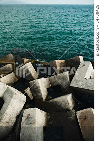 Concrete blocks of breakwater in sea 34739428